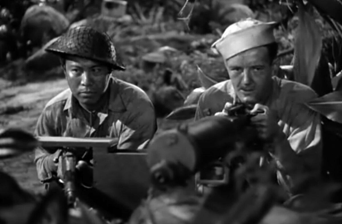 Yankee Salazar (Alex Havier, L) and sailor Leonard Purckett (Robert Walker) guard the perimeter together, in “Bataan.” (Metro-Goldwyn-Mayer)