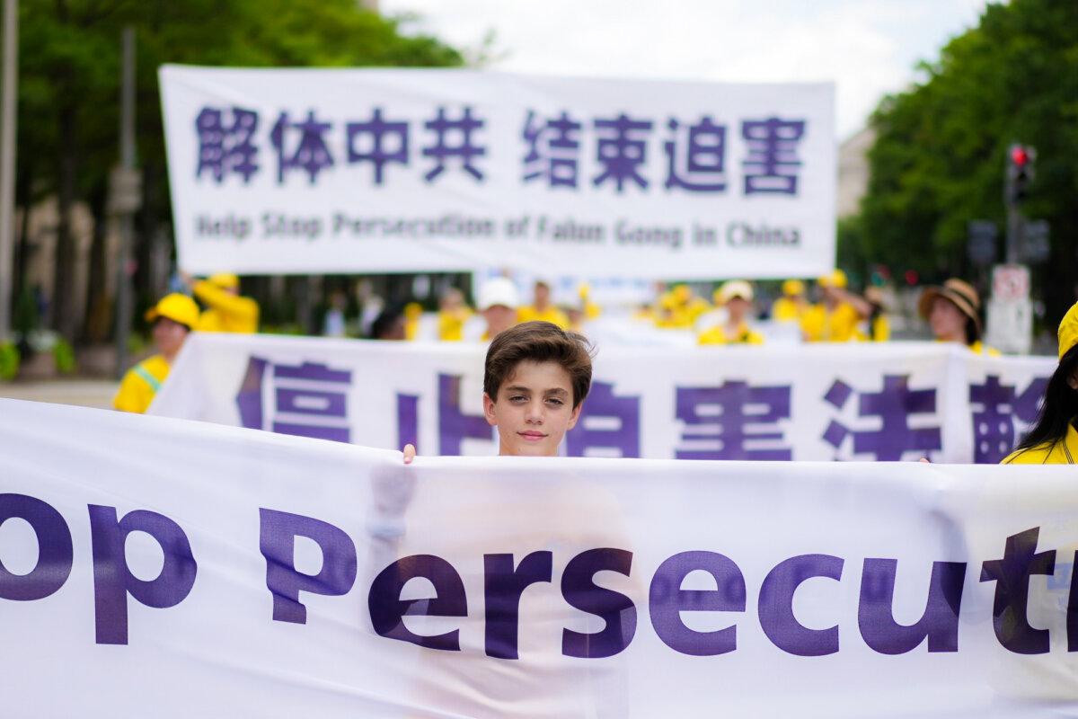 Falun Dafa practitioners take part in a march calling for an end to the Chinese Communist Party’s 26 years of persecution of Falun Gong in China, in Washington on July 17, 2025. (Madalina Kilroy/The Epoch Times)