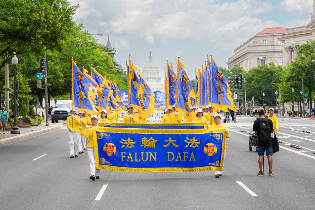 Falun Dafa practitioners take part in a march calling for the end of the Chinese Communist Party’s 26 years of persecution of Falun Gong in China, in Washington on July 17, 2025. (Madalina Kilroy/The Epoch Times)