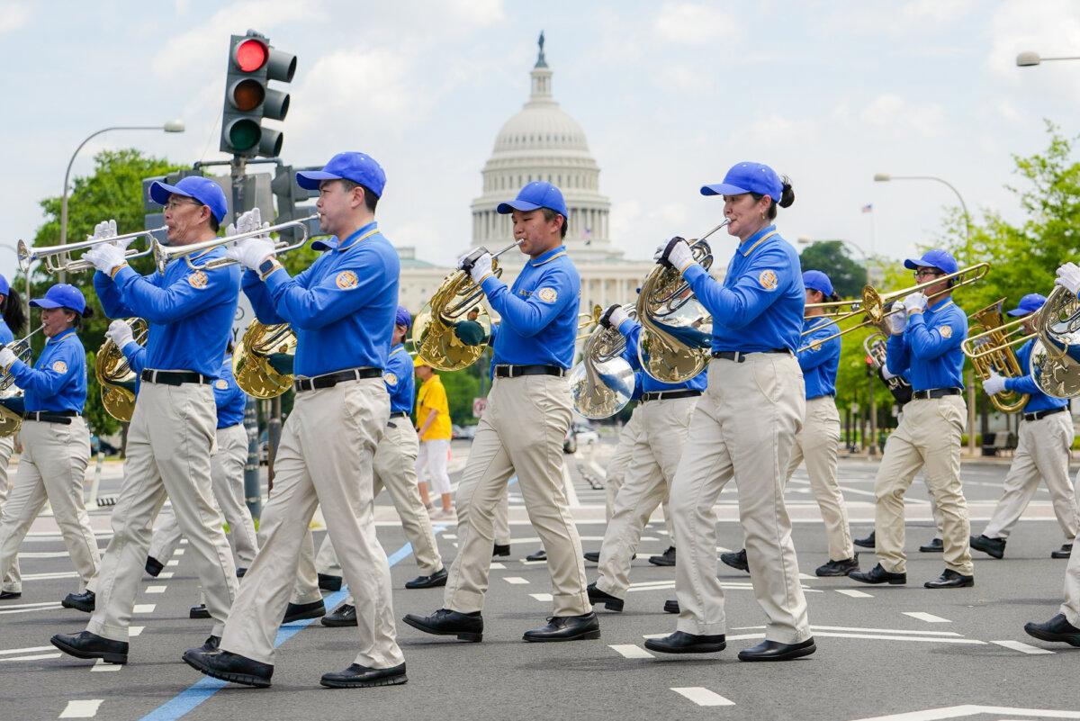 Falun Dafa practitioners take part in a march calling for an end to the Chinese Communist Party’s 26 years of persecution of Falun Gong in China, in Washington on July 17, 2025. (Madalina Kilroy/The Epoch Times)