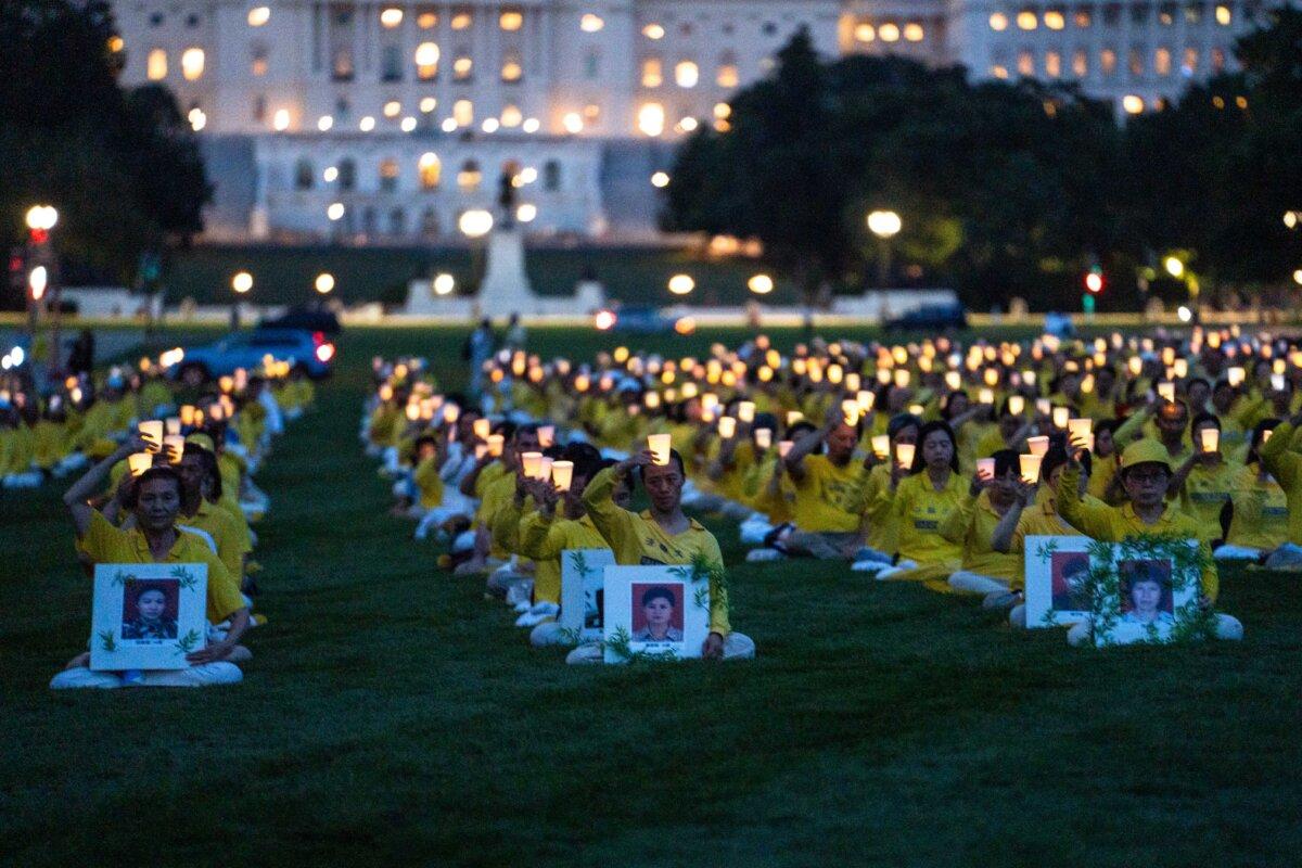 Falun Gong practitioners take part in a candlelight vigil commemorating Falun Gong practitioners who were persecuted to death by the Chinese Communist Party in China, in Washington on July 17, 2025. (Madalina Kilroy/The Epoch Times)