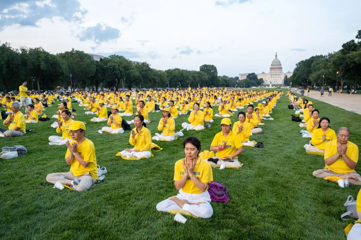 Falun Dafa practitioners practice the exercises ahead of a candlelight vigil commemorating Falun Gong practitioners who were persecuted to death by the Chinese Communist Party in China, in Washington on July 17, 2025. (Samira Bouaou/The Epoch Times)