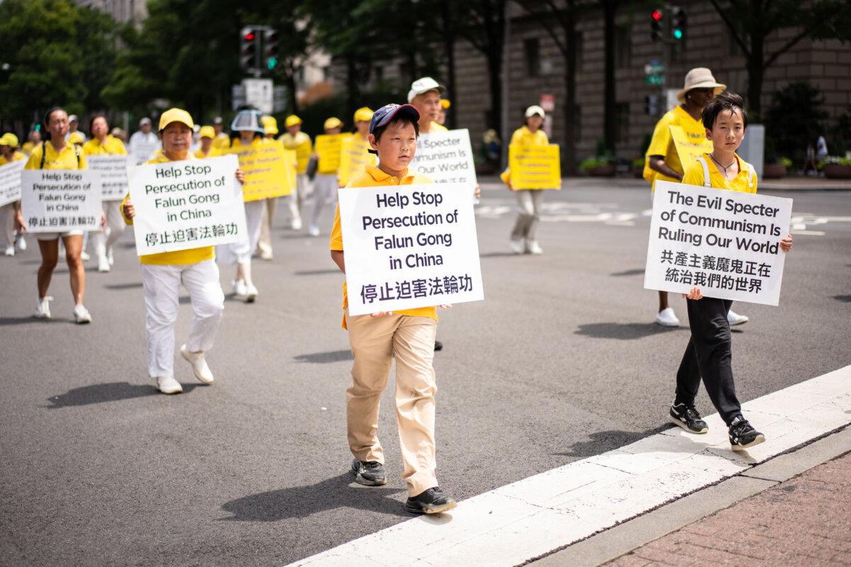 Falun Dafa practitioners take part in a march calling for the end of the Chinese Communist Party’s 26 years of persecution of the practice in China, in Washington on July 17, 2025. (Madalina Kilroy/The Epoch Times)