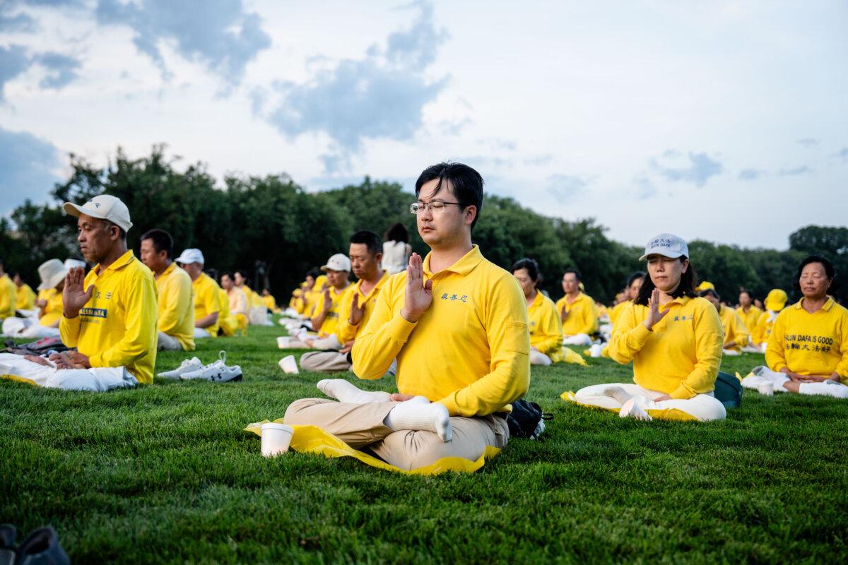 Falun Dafa practitioners ahead of taking part in a candlelight vigil commemorating Falun Gong practitioners who were persecuted to death in China by the Chinese Communist Party, in Washington, on July 17, 2025. (Madalina Kilroy/The Epoch Times)