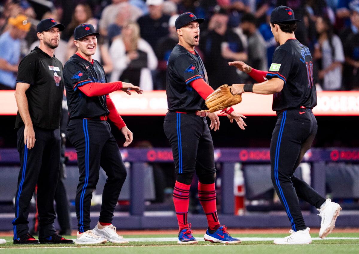 Joey Loperfido #10, George Springer #4, Will Wagner #7, and Max Scherzer #31 celebrate defeating the San Francisco Giants in their MLB game at the Rogers Centre in Toronto, Ontario, Canada, on July 18, 2025. (Mark Blinch/Getty Images)