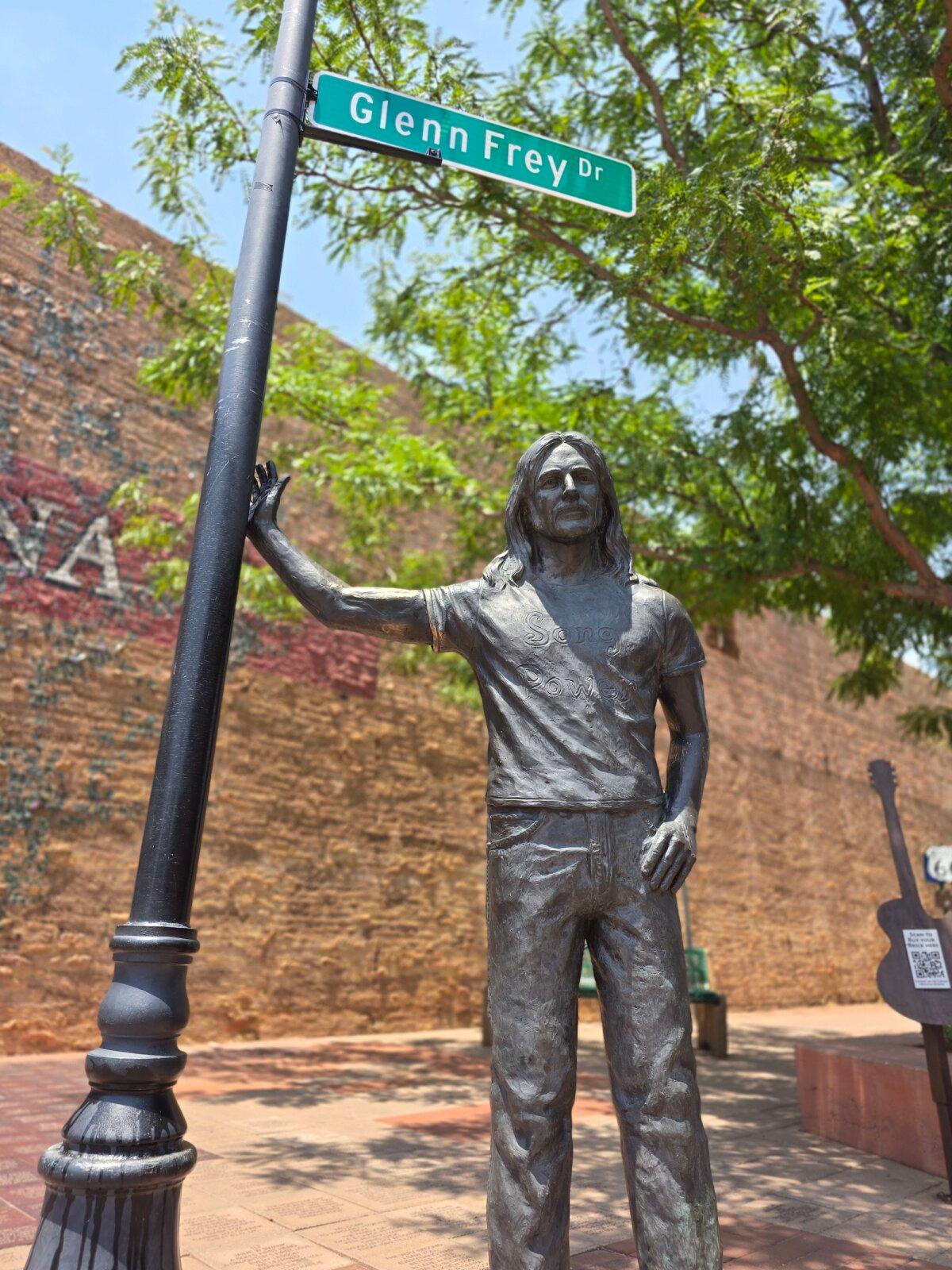 A metal statue of Glenn Frey, co-founder of The Eagles, stands on a corner in Winslow, Ariz., on July 16, 2025. (Allan. Stein/The Epoch Times)