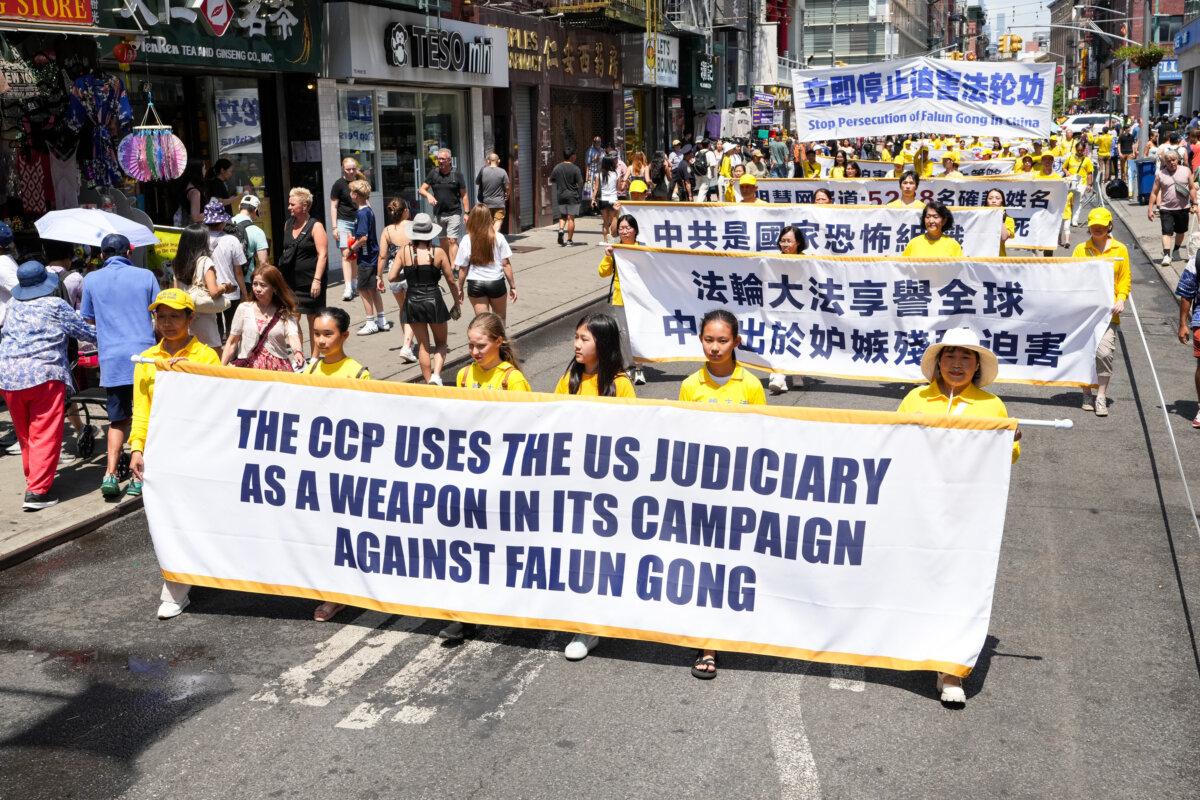 Falun Gong practitioners march during a parade calling for the end of the Chinese Communist Party’s 26 years of ongoing persecution against the spiritual practice, in New York City on July 20, 2025. (Larry Dye/The Epoch Times)