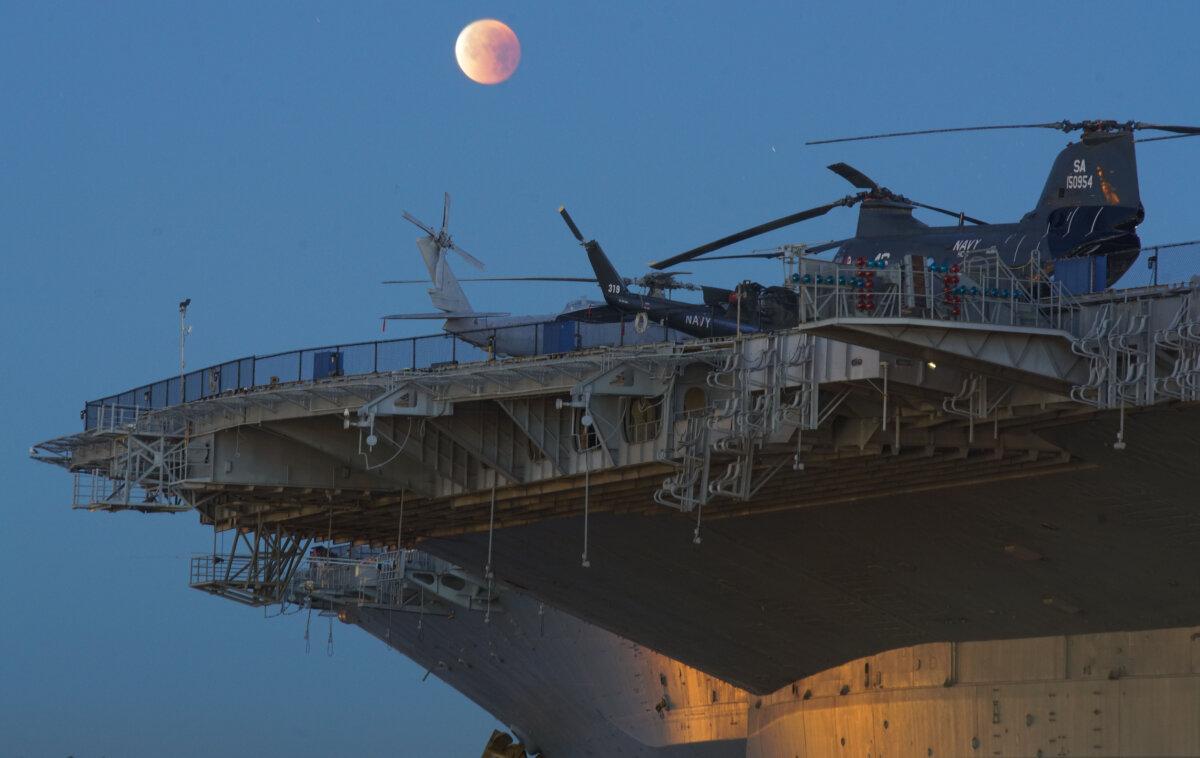 A view of the moon rising over the USS Midway in San Diego on Jan. 31, 2018. (Sandy Huffaker/AFP via Getty Images)