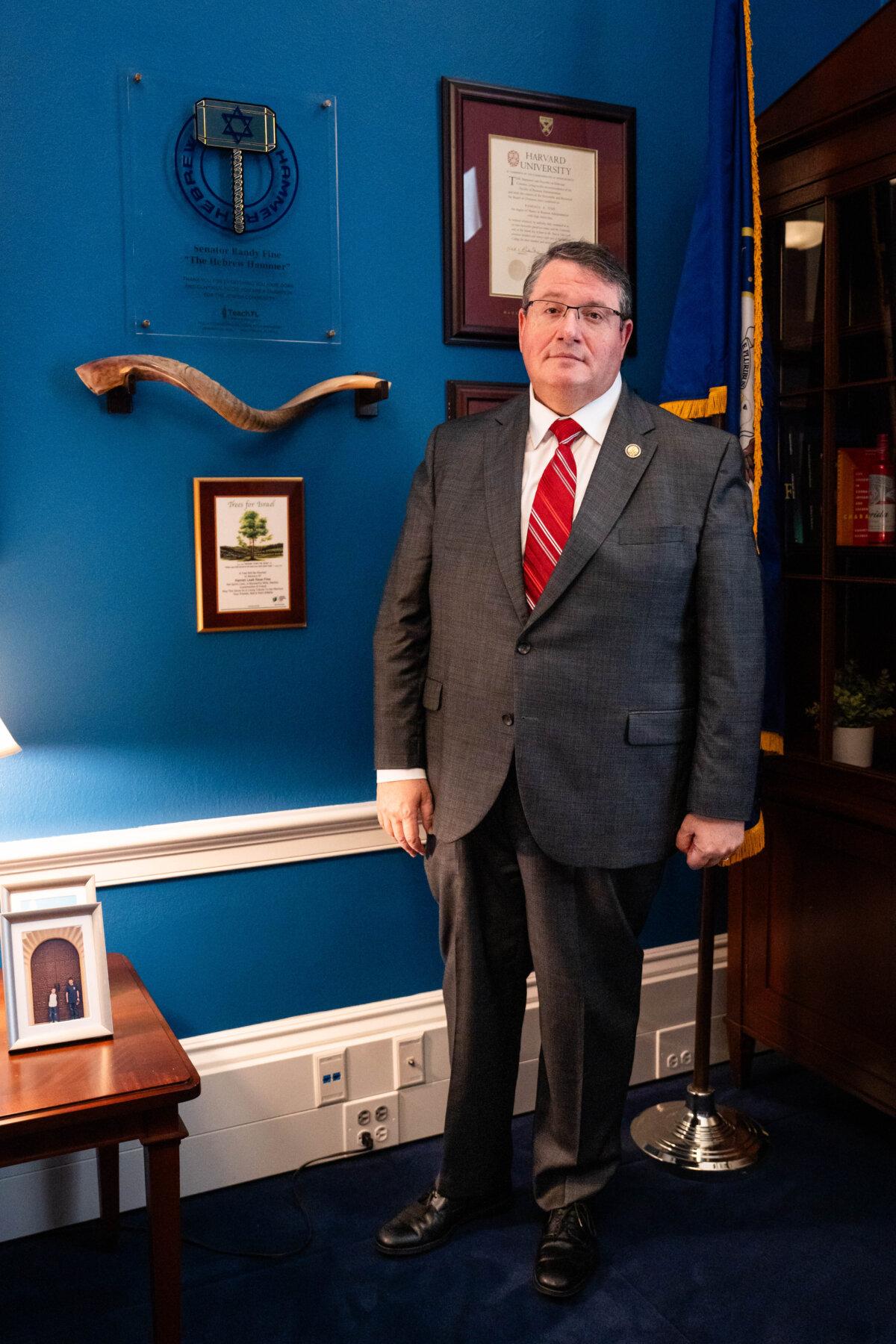Rep. Randy Fine (R-Fla.) stands next to an award noting his nickname, "The Hebrew Hammer," on a wall of his office on Capitol Hill in Washington on July 22, 2025. (Madalina Kilroy/The Epoch Times)