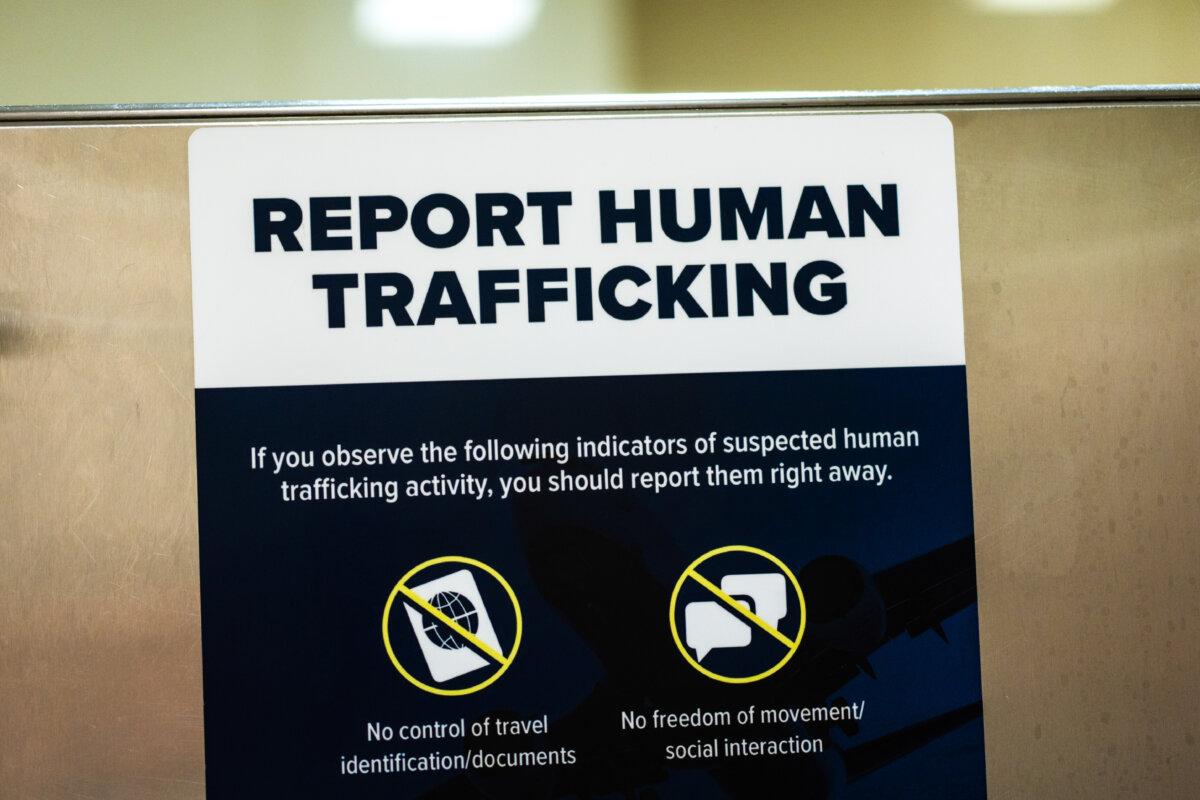 A sign warning about human trafficking at Ronald Reagan Washington National Airport in Arlington, Va., on July 3, 2025. (Madalina Kilroy/The Epoch Times)