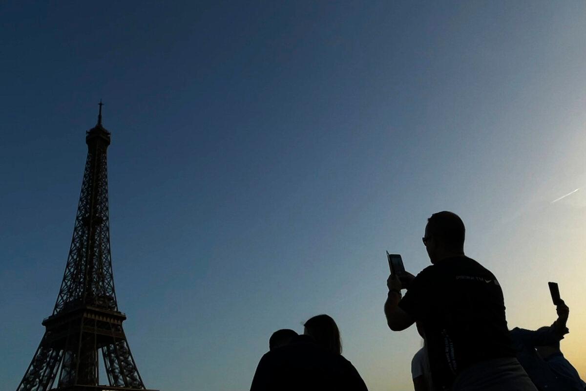 People are silhouetted as they photograph the Eiffel Tower in Paris on Oct. 8, 2023. (Heather Khalifa/The Philadelphia Inquirer/TNS)