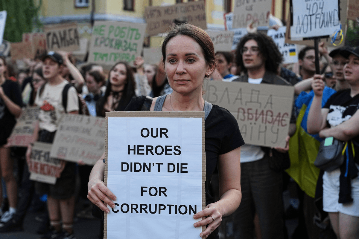 A woman holds a banner during a protest against a law targeting anti-corruption institutions in central Kyiv, Ukraine, on July 23, 2025. (Efrem Lukatsky/AP Photo)