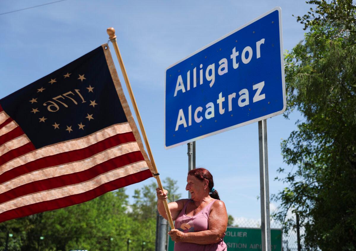 Rana Mourer waves an American flag outside of the illegal immigrant detention facility dubbed "Alligator Alcatraz," at the Dade-Collier Training and Transition facility in Ochopee, Fla., on July 12, 2025. (Alexandra Rodriguez/AP Photo)