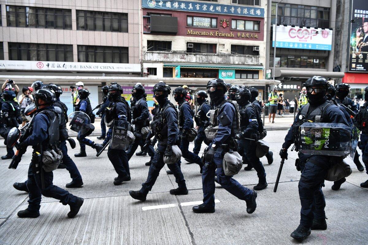 Riot police march down a street as they take action to disperse protesters taking part in a pro-democracy rally in Hong Kong, on May 24, 2020. (Anthony Wallace/AFP via Getty Images)