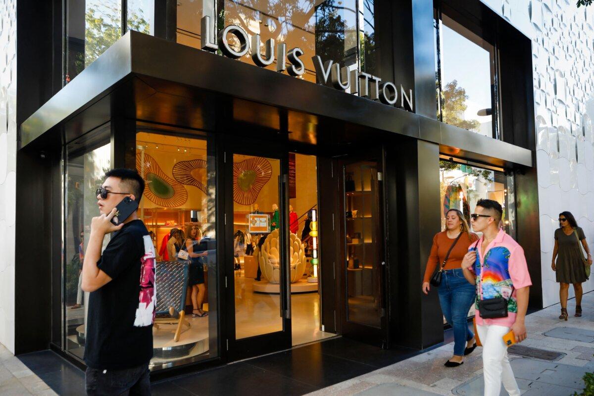 People walk by the Louis Vuitton store in Miami, Fla. (Eva Marie Uzcategui/AFP via Getty Images)