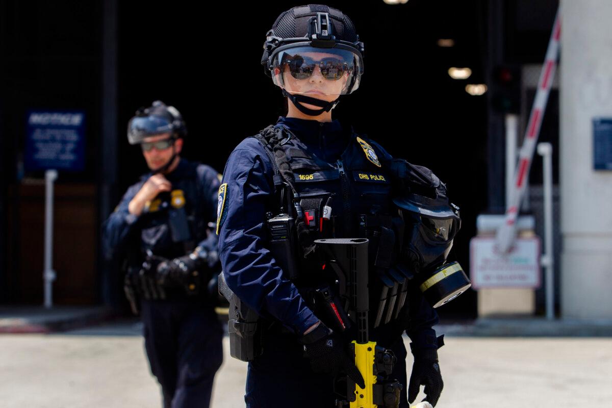 Newsom Files Records Request for ICE Operation Near Redistricting Press Conference 2 Department of Homeland Security (DHS) officers stand guard in front of the Edward R. Roybal Federal building and Detention Center while demonstrators protest in Los Angeles on Aug. 2, 2025. (Apu Gomes/Getty Images)
