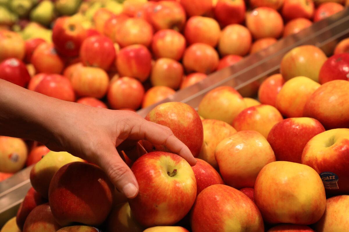 A shopper selects fresh produce at a grocery store in Sydney, Australia, on March 25, 2025. (Lisa Maree Williams/Getty Images)