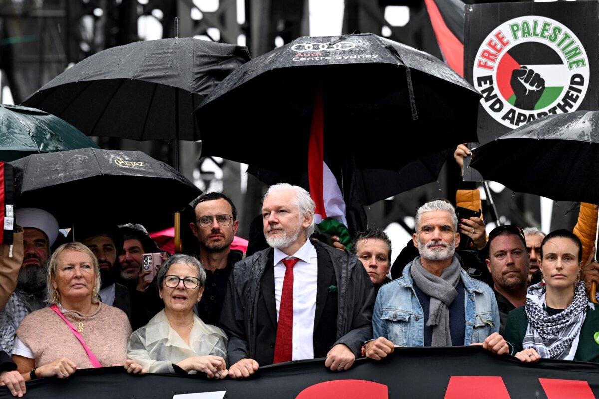 Demonstrators, including WikiLeaks founder Julian Assange (C), cross the Sydney Harbour Bridge during a pro-Palestinian rally against Israel and ongoing food shortages in the Gaza Strip, in Sydney, Australia on Aug. 3, 2025. (Saeed Khan/AFP via Getty Images)