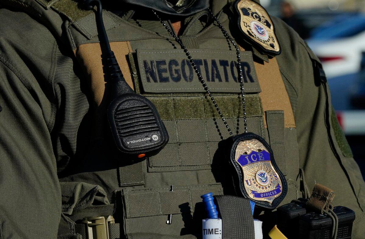 Immigration and Customs Enforcement agents stand near a gate at a detention centre in Newark, N.J., on May 7, 2025. (Timothy A. Clary/AFP/Getty Images)