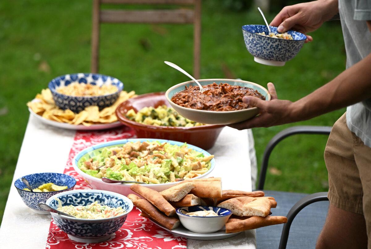 Sam brings out the pulled pork at a cookout at Gretchen’s house on Wednesday, July 16, 2025. (Lucy Schaly/Pittsburgh Post-Gazette/TNS)