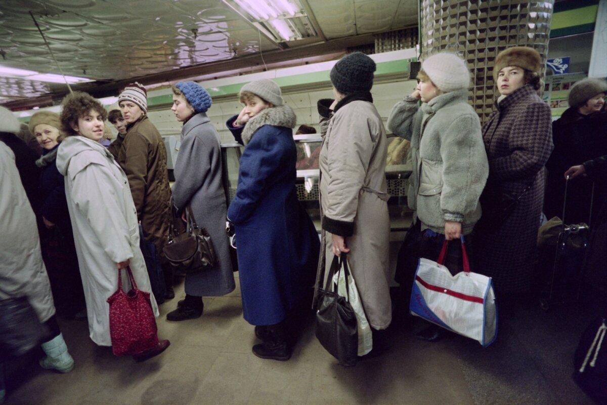 Soviet women queue in a grocery store with empty and deserted refrigerated racks, in Moscow, the USSR, on Dec. 8, 1990. (Serguei/AFP via Getty Images)