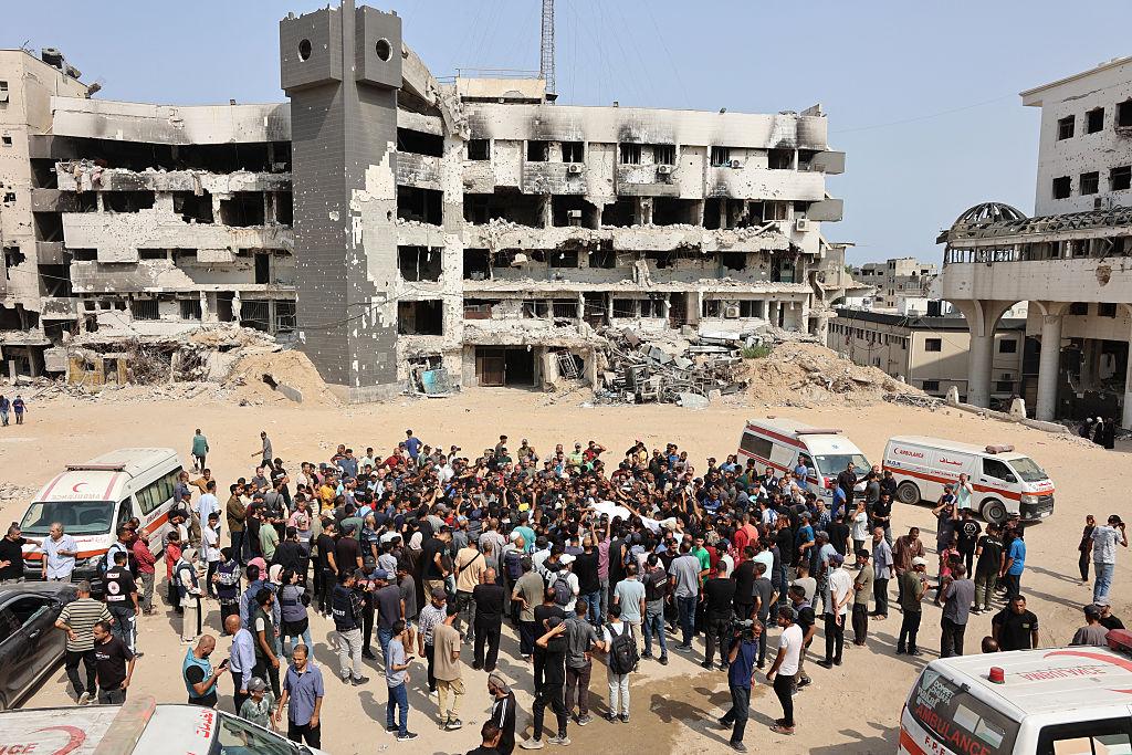 Mourners carry bodies of Palestinians killed in an overnight Israeli strike, ahead of a group funeral outside the Al-Shifa Hospital in Gaza City on Aug. 11, 2025. (Omar Al-Qattaa/AFP via Getty Images)