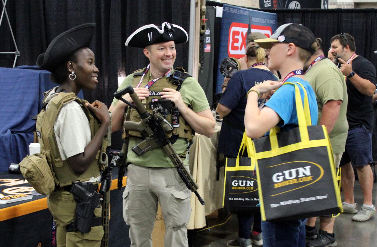 Modern Minutemen talk with attendees during the Gun Owners Advocacy Leadership Summit in Knoxville, Tenn., on Aug. 9, 2025. (Michael Clements/The Epoch Times)