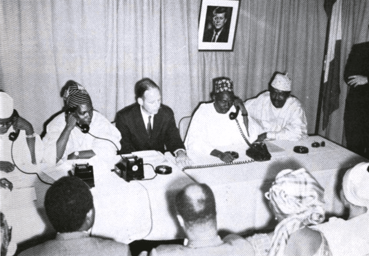 Prime Minister Balewa (2nd from R) talks to President John F. Kennedy on the first live broadcast via the Syncom 2 satellite from USNS Kingsport in Lagos, Nigeria. (Public Domain)