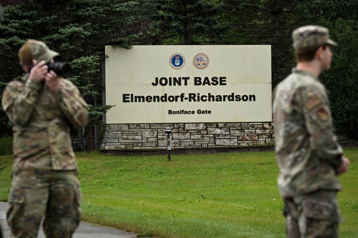 Members of the military stand outside an entrance to Joint Base Elmendorf-Richardson in Anchorage, Alaska, on Aug. 14, 2025, ahead of the Aug. 15 scheduled meeting between U.S. President Donald Trump and Russian President Vladimir Putin. (Drew Angerer/AFP via Getty Images)