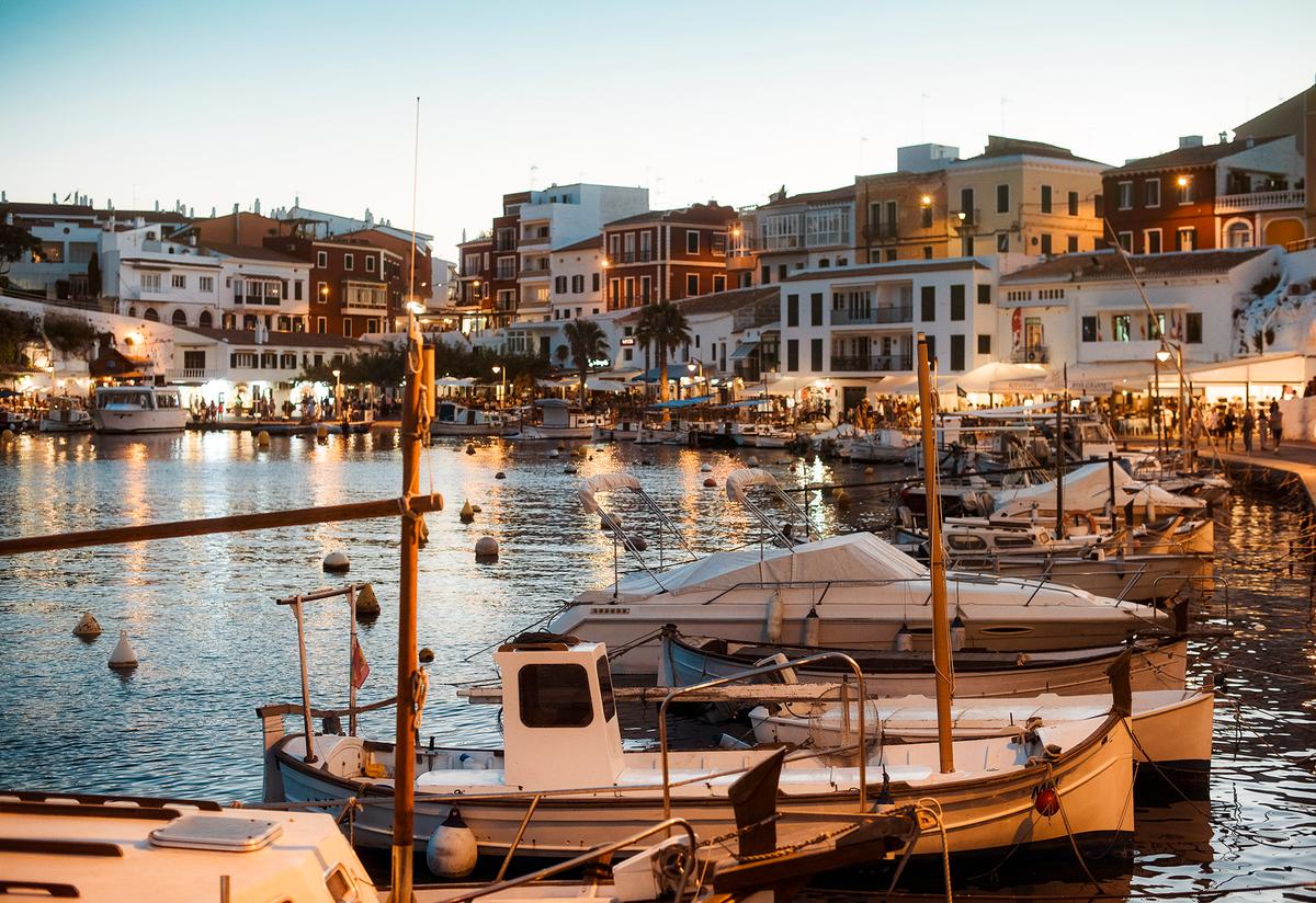 Es Castell's waterfront, known as Cales Fonts, is a picturesque harbor lined with restaurants and fishing boats. (Max Bailen/Getty Images)