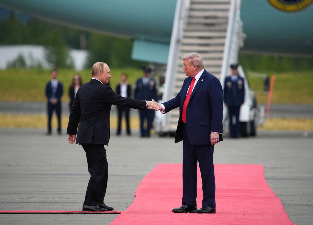 President Donald Trump (R) greets Russian President Vladimir Putin as he arrives at Joint Base Elmendorf-Richardson in Anchorage, Alaska, on Aug. 15, 2025. (Andrew Harnik/Getty Images)