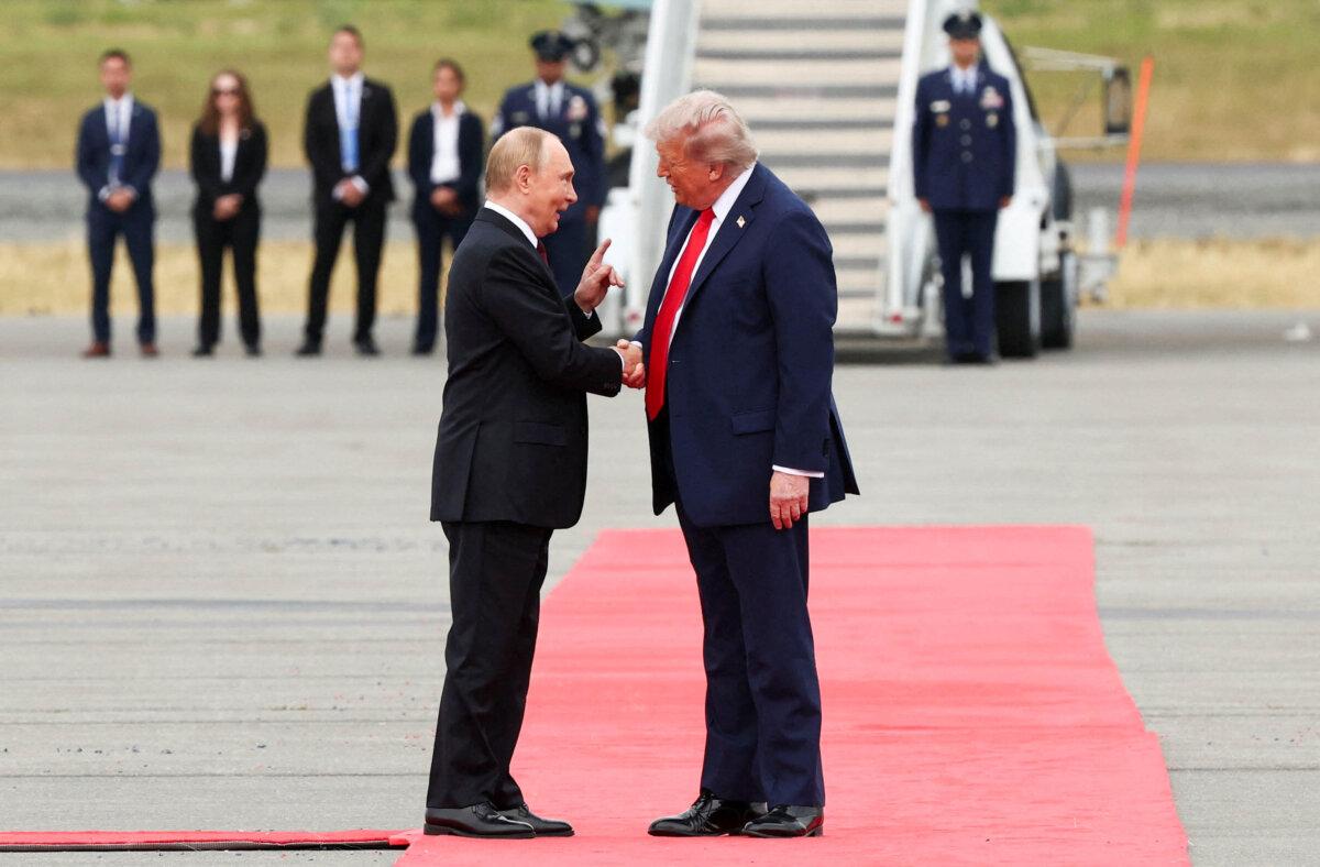 U.S. President Donald Trump shakes hands with Russian President Vladimir Putin, as they meet to negotiate for an end to the war in Ukraine, at Joint Base Elmendorf-Richardson in Anchorage, Alaska, on Aug. 15, 2025. (Reuters/Kevin Lamarque)