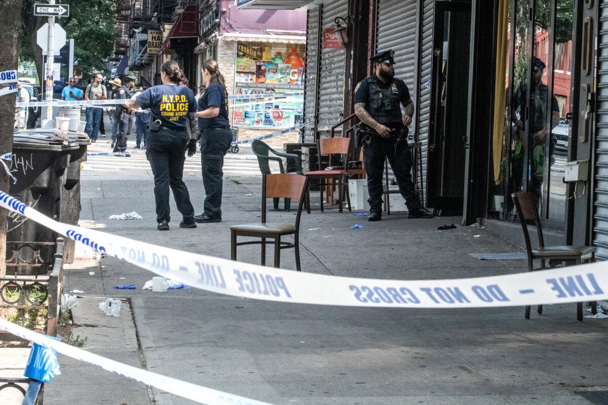 Members of the New York City Police Department (NYPD) investigate a shooting scene at Taste of the City lounge in the Crown Heights neighborhood of the Brooklyn borough in New York City on Aug. 17, 2025. (Stephanie Keith/Getty Images)