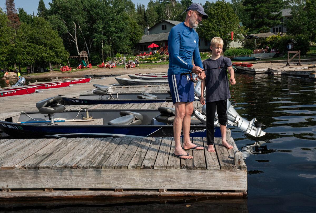 James Appleby and his son, Indiana, try out fishing on the dock. (Richard Tsong-Taatarii/The Minnesota Star Tribune/TNS)