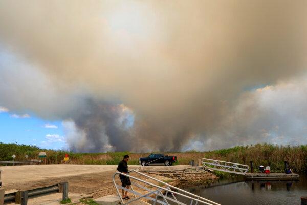 Day in Photos: Brushfire in Florida, Bus Crash in Afghanistan, and Sail-In Parade