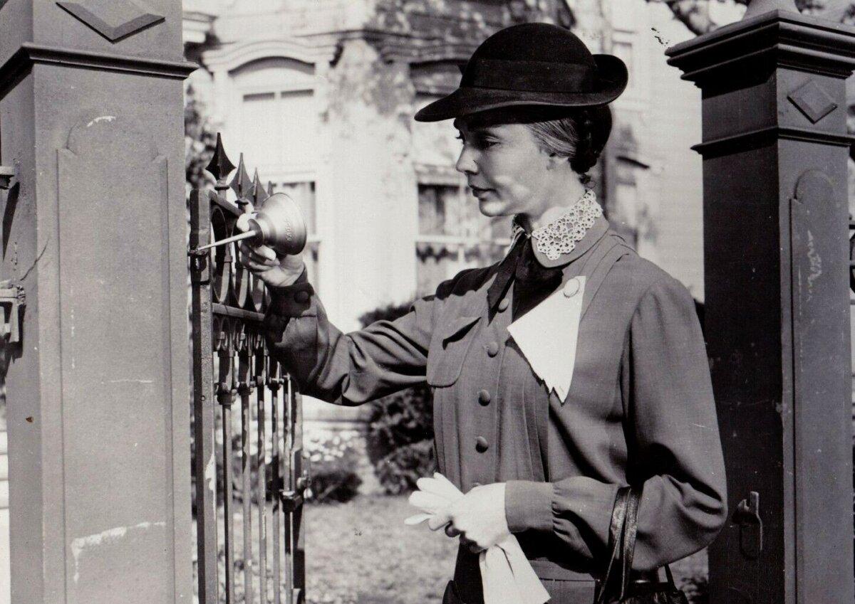 Miss Dove (Jennifer Jones) oils the hinge of her gate, in “Good Morning, Miss Dove.” (20th Century Fox