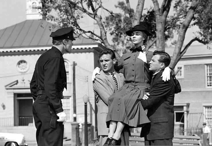 Former students help their teacher: (L–R) Officer Bill Holloway (Chuck Connors), Dr. Baker (Robert Stack), Miss Dove (Jennifer Jones), and Rev. Alex Burnham (Biff Elliot), in “Good Morning, Miss Dove.” (20th Century Fox)