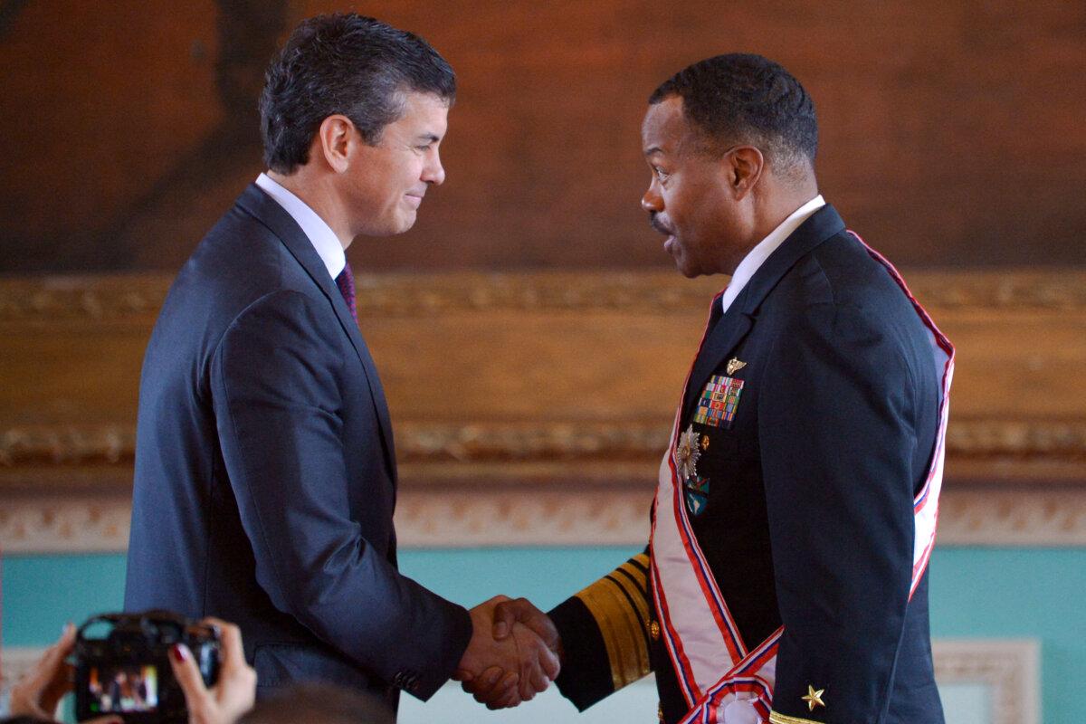 The head of the U.S. Southern Command, Admiral Alvin Holsey (R), shakes hands with Paraguay's President Santiago Pena at the Government Palace in Asuncion, Paraguay, on Aug. 23, 2025. (Daniel Duarte/AFP via Getty Images)
