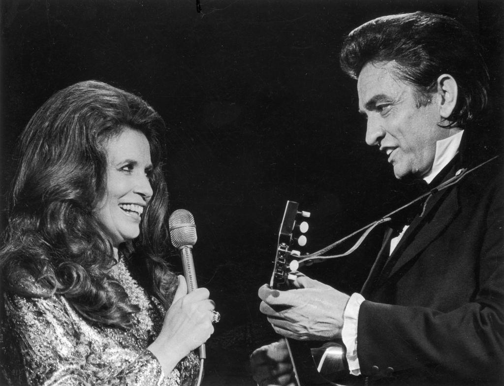 Married country singers June Carter Cash and Johnny Cash perform a duet on stage. (Photo by Archive Photos/Getty Images)
