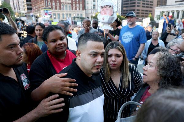 Surrounded by reporters, Kilmar Abrego Garcia and his wife, Jennifer Vasquez Sura, enter a U.S. Immigration and Customs Enforcement (ICE) field office in Baltimore, Md., on Aug. 25, 2025. (Anna Moneymaker/Getty Images)