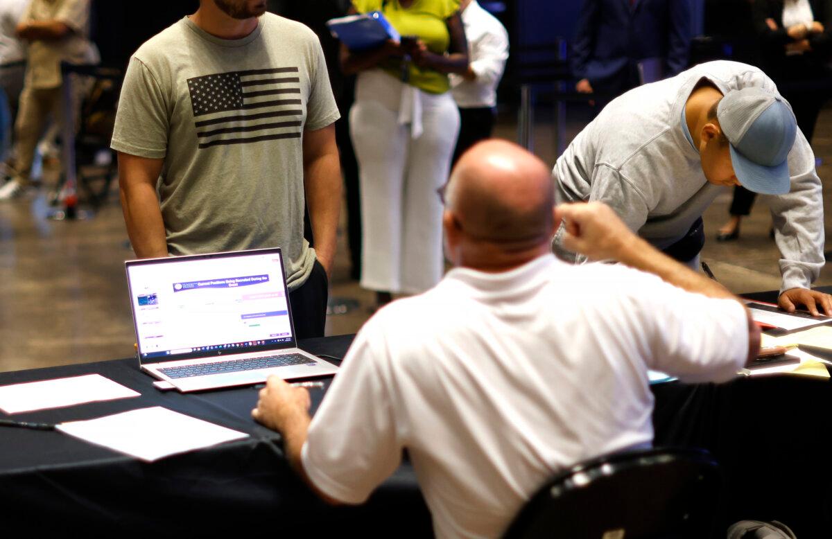 People speak with recruiters as U.S. Immigration and Customs Enforcement (ICE) holds a major hiring event in Arlington, Texas, on Aug. 26, 2025. (Ron Jenkins/Getty Images)