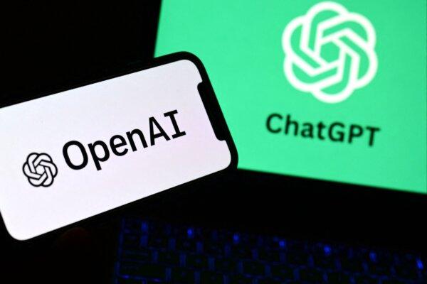 A smartphone and a laptop displaying the logos of the artificial intelligence OpenAI research laboratory and ChatGPT robot, in Manta, Italy, on Oct. 4, 2023. (Marco Bertorello/AFP via Getty Images)