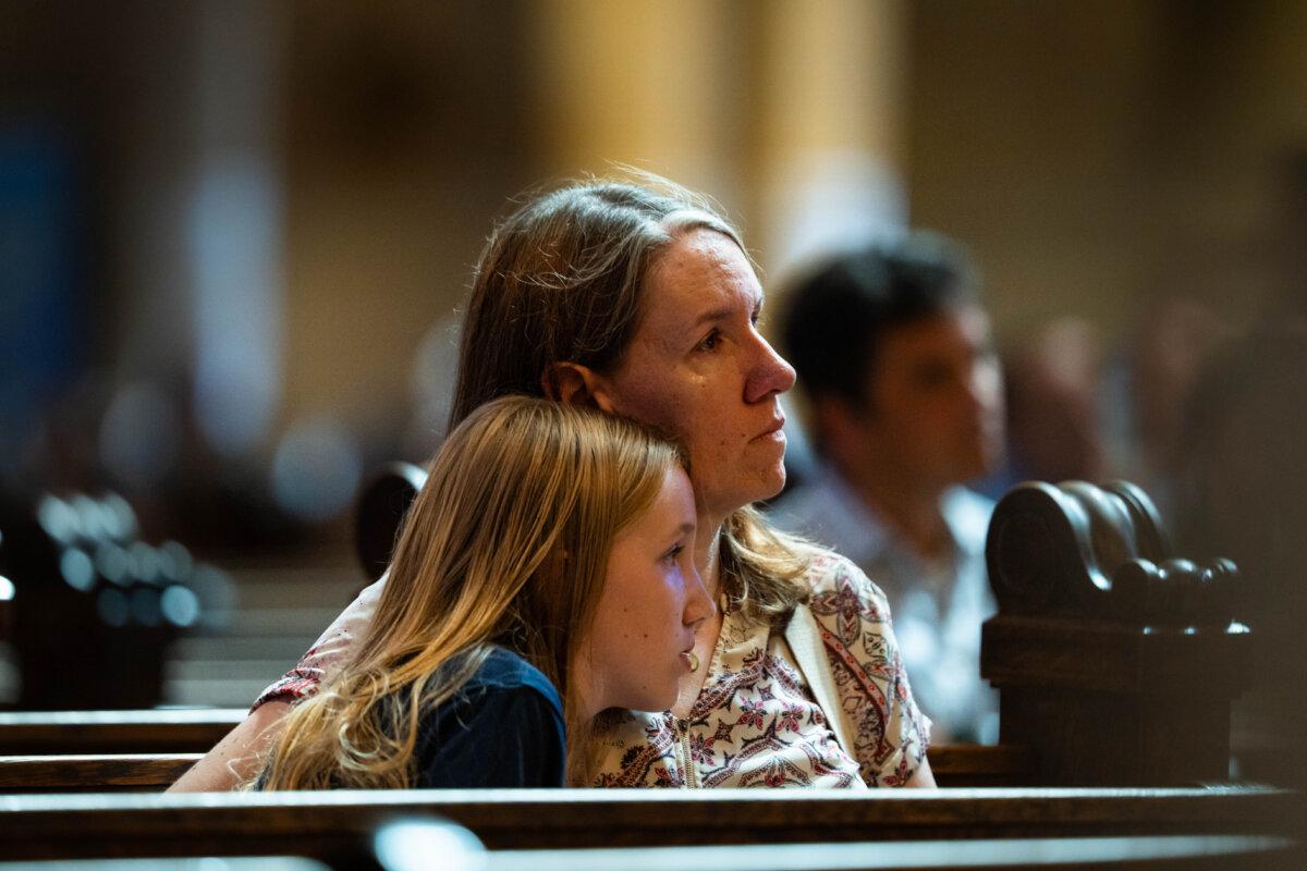 People pray at the Cathedral of Saint Paul, in the aftermath of the Annunciation Catholic School shooting, in Saint Paul, Minn., on Aug. 28, 2025. (Madalina Kilroy/The Epoch Times)
