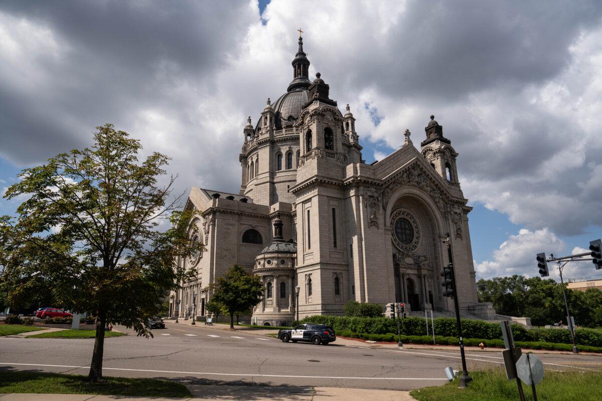 In the wake of a fatal shooting at Annunciation Catholic Church in nearby Minneapolis, a police car drives by the Cathedral of Saint Paul in Saint Paul, Minn., on Aug. 28, 2025. (Madalina Kilroy/The Epoch Times)