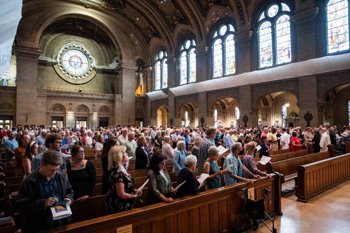 In the aftermath of a fatal shooting at Annunciation Catholic Church, people attend an interfaith prayer service at the Basilica of Saint Mary in Minneapolis on Aug. 28, 2025. (Madalina Kilroy/The Epoch Times)