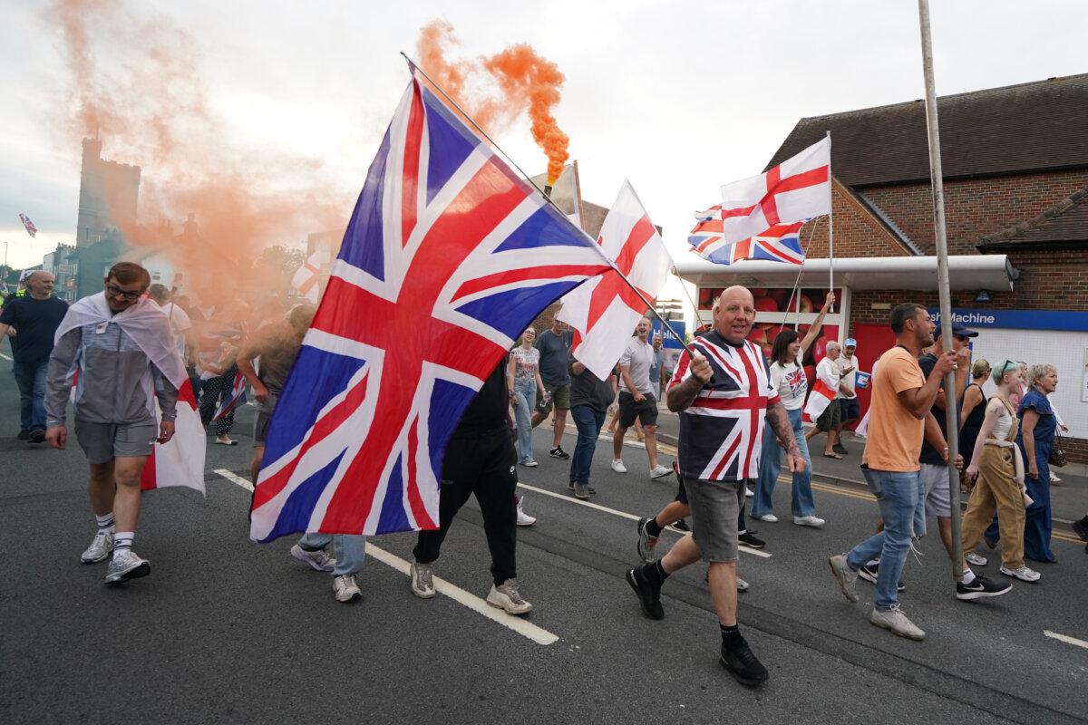 People demonstrating under the Abolish Asylum System slogan outside the former Bell Hotel in Epping on Aug. 24, 2025. (Gareth Fuller/PA)