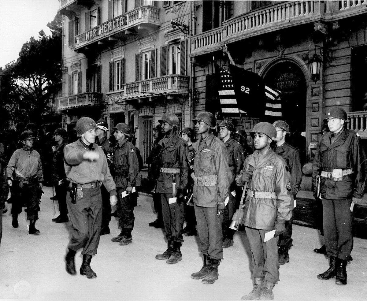 Maj. Gen. Edward Almond, commanding general of the 92nd Infantry Division, inspects his troops during a decoration ceremony, March 1945. (Public Domain)
