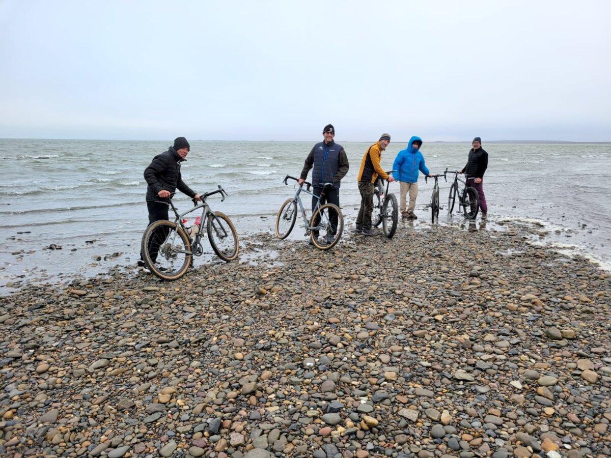 Lloyd Taylor (L) and his teammates reach the Arctic Ocean to officially end the northern portion of their tour in September 2024. (Courtesy Spinning Wheels Tour)
