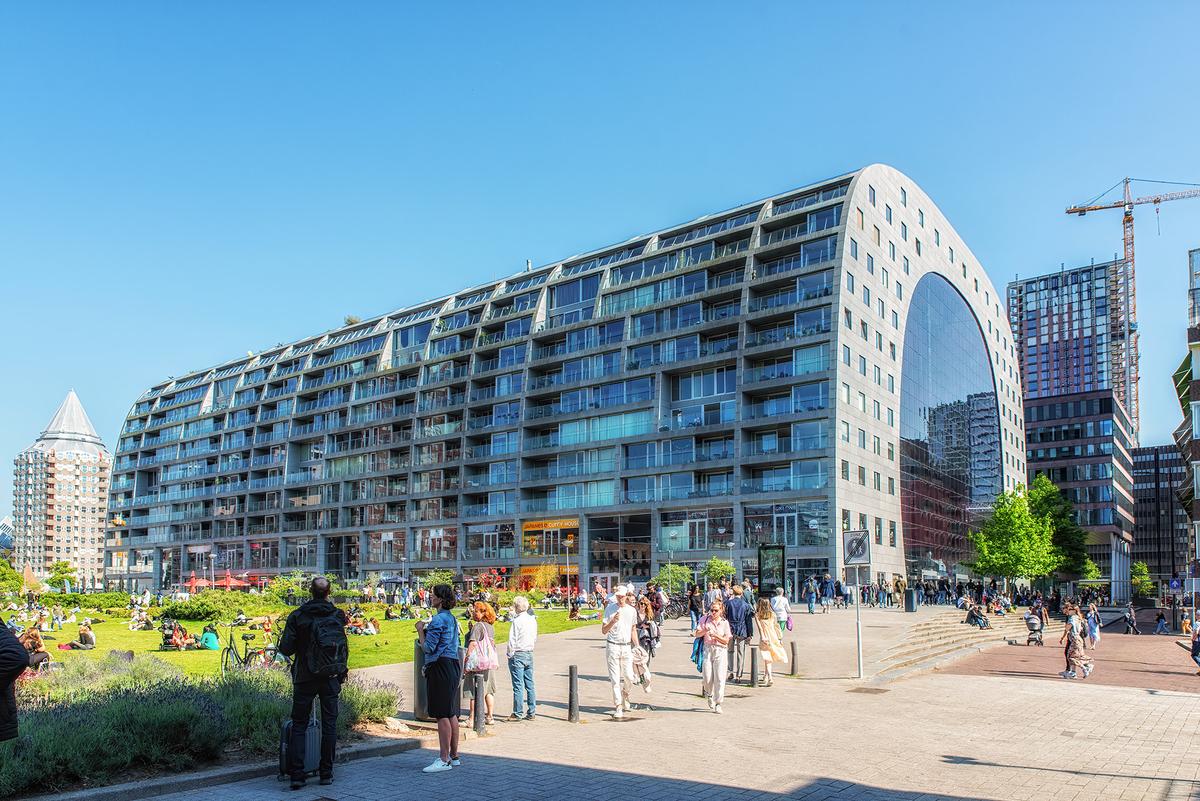 The Market Hall is one of Rotterdam's most striking buildings, consisting of a large, arch-shaped structure that houses apartments in the outer shell and a food market inside. (Atosan/Shutterstock)