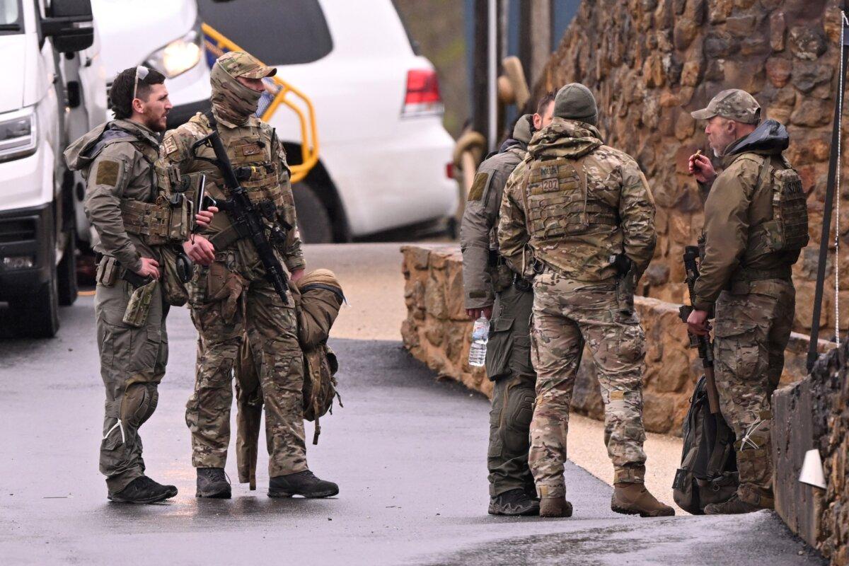Heavily armed police gather at a police staging point during the search for a fugitive linked to the murder of two police officers, in Porepunkah on Aug. 28, 2025. (William West/AFP via Getty Images)